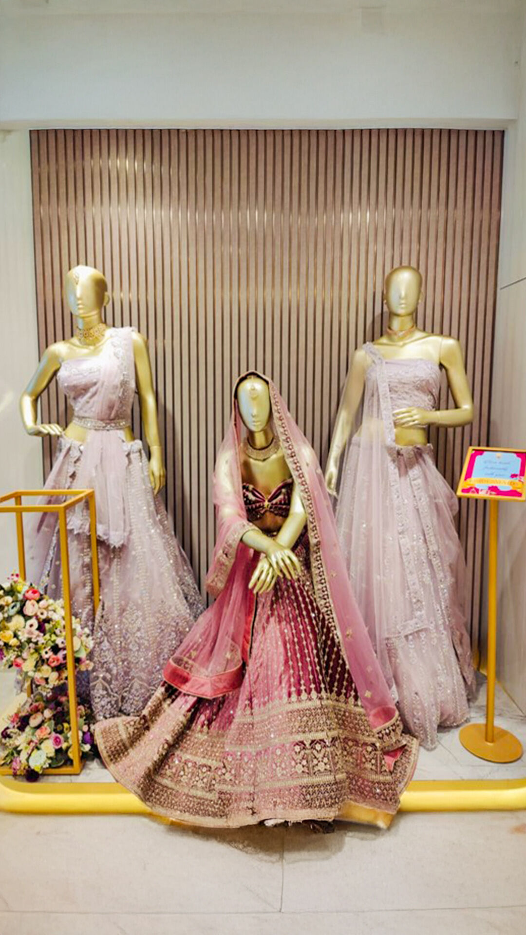 Beautiful pink and red lehengas on display, perfect for budget-conscious brides.